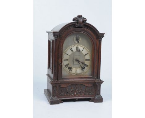 A Victorian Art Nouveau oak mantle clock
With a 15cm silvered arched dial signed Byrne & Son Ltd., Liverpool with Roman numer