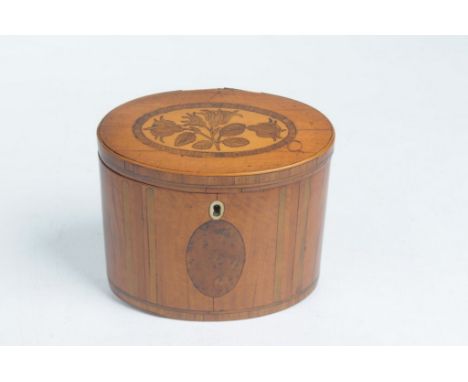 A fine George III inlaid satinwood oval tea caddy
The hinged cover inlaid with marquetry flowers and leaves within a rosewood
