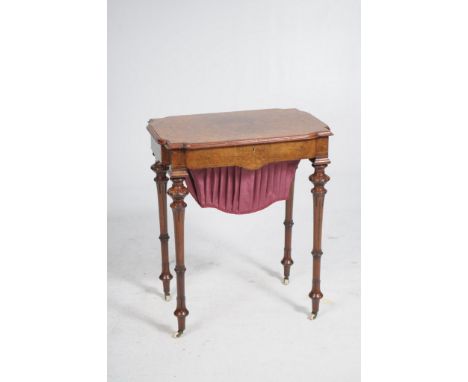 A fine early Victorian bur walnut and inlaid sewing table
The shaped rectangular top with re-entrant angles, moulded border i