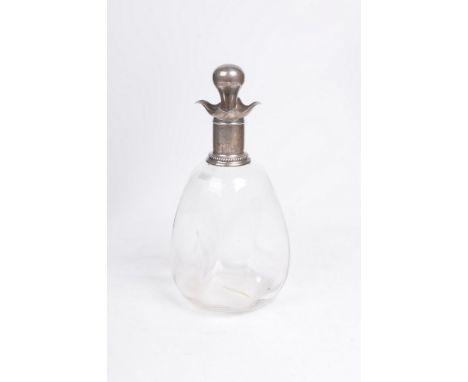 An early 20th Century silver topped dimple decanter
The clear glass bottle, surmounted by rope work borders, and scalloped an
