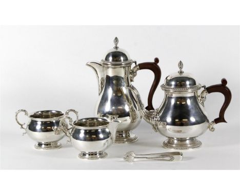 A hallmarked silver four piece tea service
Comprising teapot, hot water jug, twin handled sugar bowl, milk jug, each of balus