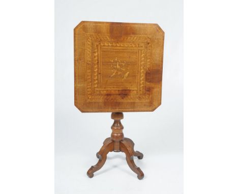 A Victorian walnut and Tumbridge Ware tripod table
The shaped square top inlaid with a marquetry panel depicting birds perche