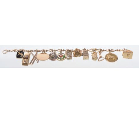 A 9ct fancy curb link charm bracelet
Variously set with thirteen 9ct and unmarked gold charms to include a pair of skis, a Ne