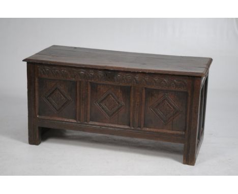 A 17th Century oak three panel blanket chest
The rectangular hinged three plank top with a moulded border above an interlaced