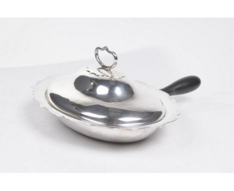 A Victorian silver lidded entree or vegetable serving dish
The oval form dish with gadrooned rim and domed cover and fixed he