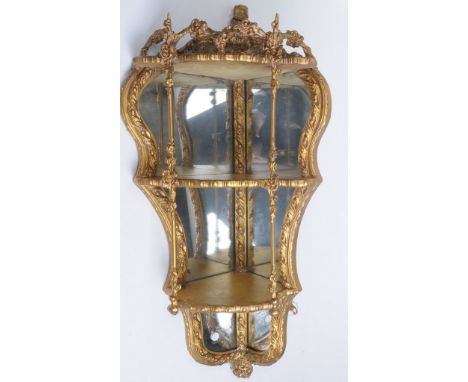 A Victorian gilt wood and composition hanging mirror back shelf
With a C scroll leaf and flower cresting, the curvilinear dow