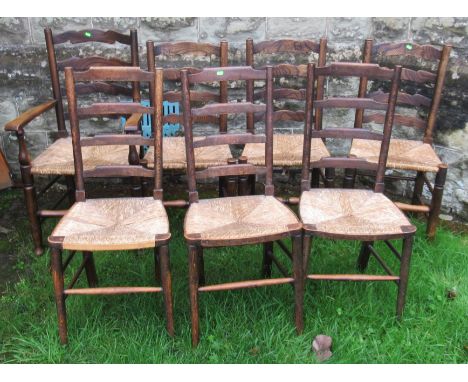 A set of four (3+1) oak ladder back chairs, with rush seats, together with another set of three