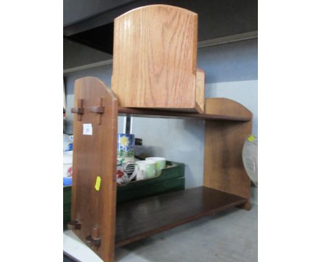 A wooden wall shelf and a book trough