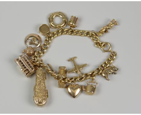 18CT YELLOW GOLD CURB LINK CHARM BRACELET having an assortment of 9ct gold charms to include a cased viola, double decker bus