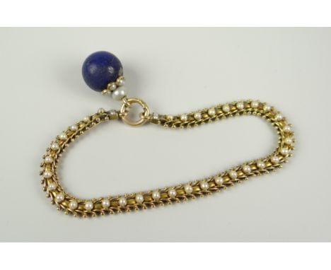 YELLOW METAL SEED PEARL SET BRACELET HAVING BELIEVED LAPIS LAZULI DROP. 17.2 grams approximately Condition Report: Appears in