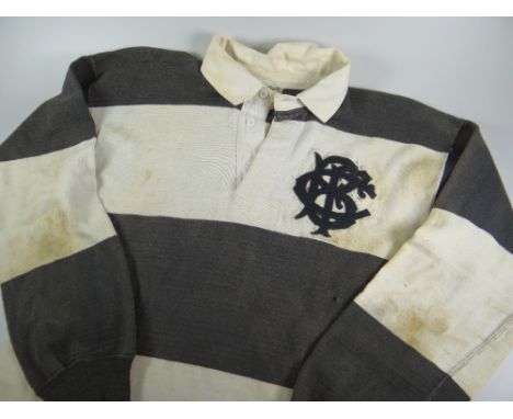 A 1950s BARBARIANS RUGBY UNION JERSEY NUMBER 4 MATCH WORN BY GARETH GRIFFITHS in traditional black and white hoops, felt embl