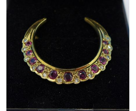 A 9ct gold, ruby and diamond crescent brooch, 2.5g