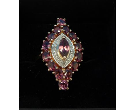 A silver gilt, rhodolite garnet and diamond ring, M