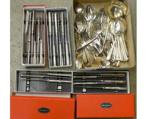 A collection of plated cutlery including boxed Walker & Hall knives and a large ladle