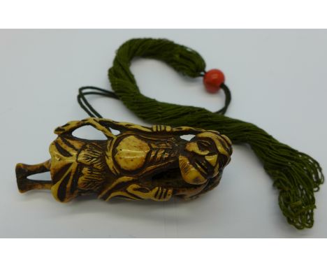 A c.1800 carved antler netsuke of a Sennin