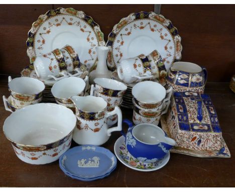 A twelve setting decorative tea service, twelve cups (one a/f), saucers, side plates, two large plates, sugar and cream and o