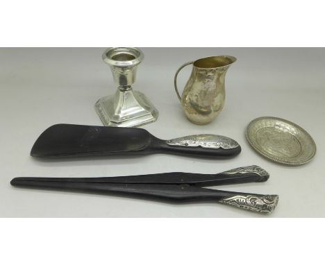 An 800 silver jug, a silver candle stick, a dish and a matching Victorian silver mounted shoe horn and glove stretchers