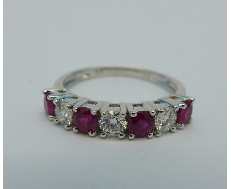 An 18ct gold, ruby and diamond ring, size M½, 2.5g, .88cts ruby and .45cts diamonds marked on shank