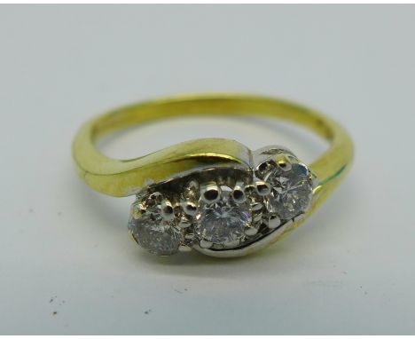 An 18ct gold, three stone diamond ring, 0.50cts stamped on shank, 4.3g, P