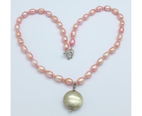 A silver and pink pearl necklace