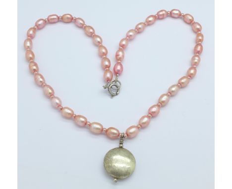 A silver and pink pearl necklace