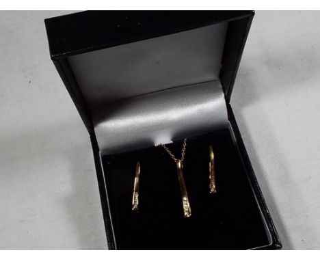 A 9 carat gold 20 pt diamond stick pendant and earring set, approx. weight 2.1 g Unused surplus retail stock - Est £40 - £60