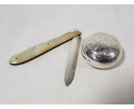 A hallmarked silver lidded snuff box and a hallmarked silver fruit knife with mother-of-pearl handle