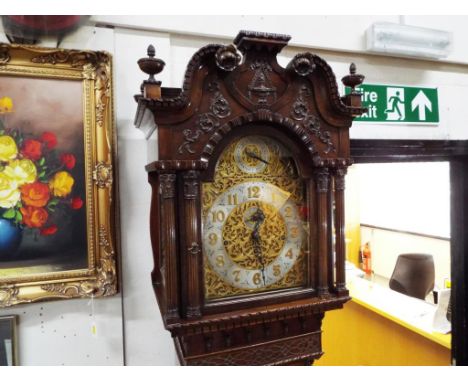 A good early 20th century Chippendale-style mahogany longcase clock, the case profusely carved with brick-work to the base, q