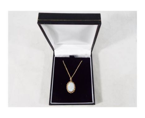 A hallmarked 9 carat gold chain with an opal pendant set in 9 carat gold, approximate weight 3.84 grams, boxed. Estimate £60 