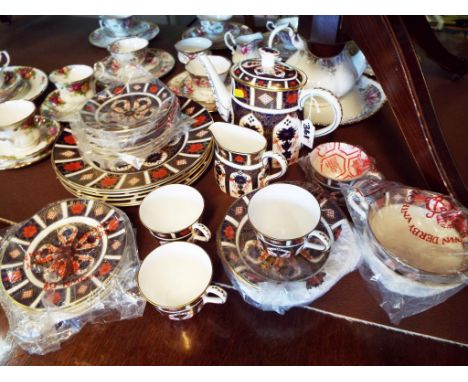 A Royal Crown Derby dinner service decorated in the Imari pattern, # 1128 comprising 31 pieces comprising four cups, five sid