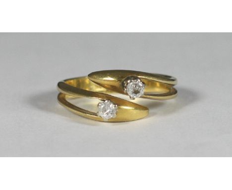 An 18ct gold crossover design ring, the top set with two diamonds, approx. total diamond weight 0.20cts, gross weight approx.