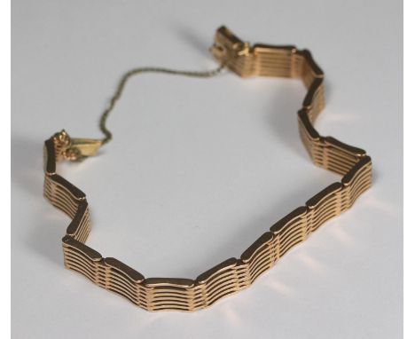 A 15ct gold seven-bar gate-bracelet, with sliding clip and safety chain, 26.0g 