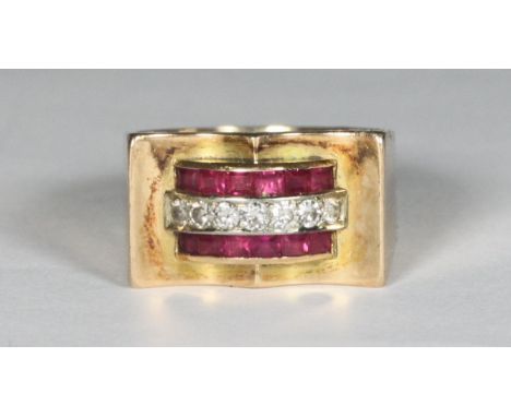 An unmarked yellow metal, ruby and diamond ring, channel set with a row of seven round faceted diamonds flanked by two rows o
