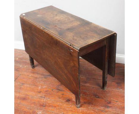A George III stained mahogany rectangular drop-leaf dining table with gate-leg stile supports, 101cm x 136cm extended 