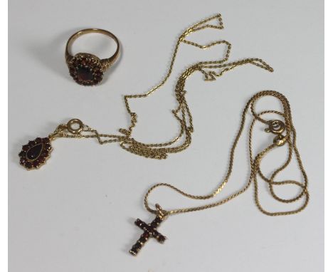 A 9ct gold and garnet set cluster ring and 9ct gold and garnet cluster pendant necklace, and 9ct gold and garnet crucifix nec