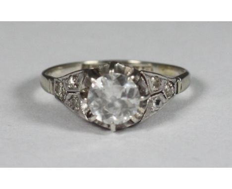 A platinum diamond ring, centrally claw set with a round, transitional cut diamond, total diamond weight approximately 1ct, i