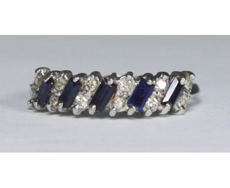 An 18ct white gold ring set with twelve diamonds and five baguette sapphire coloured stones, gross weight approx. 3.3g 