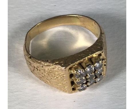 A yellow metal (tests as 18ct gold or above) gents ring, the top set with a square of nine diamonds, total diamond weight app