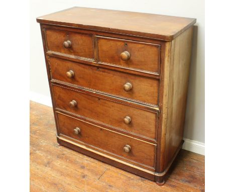A 19th century stained walnut chest of two short and three long graduated drawers, with turned pulls and brass escutcheons, 1