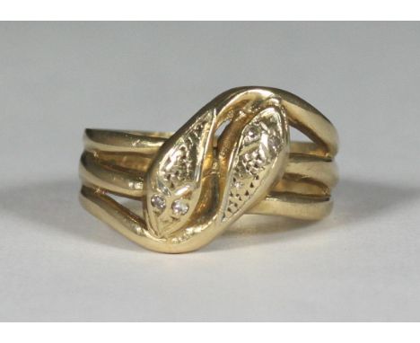 A 9ct gold ring modelled as two stylised serpents, each with two small stones for eyes, gross weight approx. 5.9g 