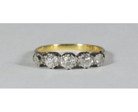 An 18ct gold and platinum ring set with five graduated diamonds, estimated total diamond weight approx. 0.70cts, gross weight