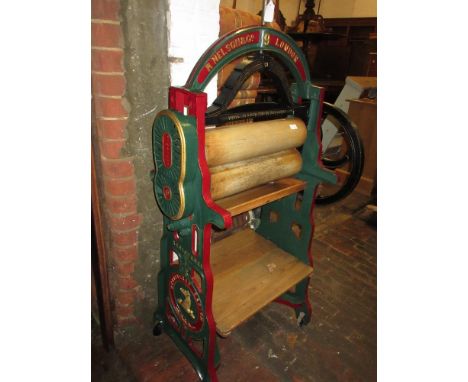 R. Nelson & Co., London, green and red painted mangle with gilt highlights, having original pine rollers, drip tray and shelv
