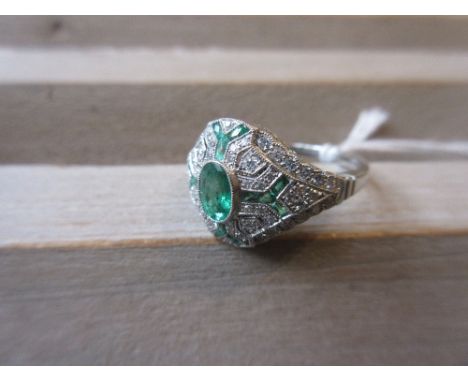 Platinum emerald and diamond set dress ring 