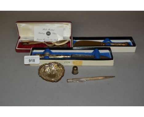 Silver handled cheese knife and butter knife, small modern silver trinket dish, three various silver spoons, a thimble and a 