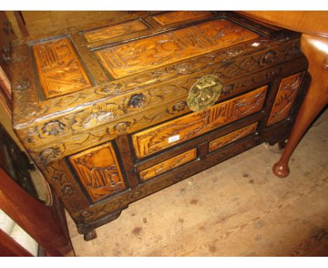 Late 20th Century carved Chinese trunk with hinged cover on low supports 