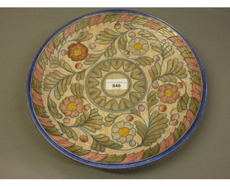 Crown Ducal Charlotte Rhead circular pottery charger with tube lined floral decoration, 12.5ins diameter 