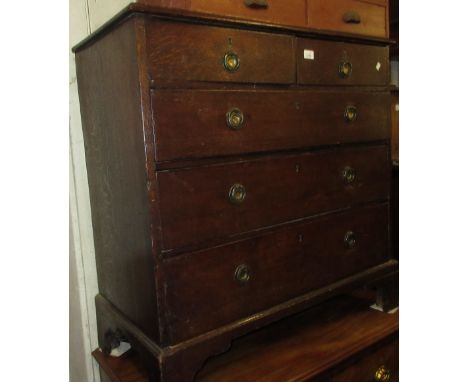 Late George III oak straight front chest of two short over three long drawers with brass ring handles raised on bracket feet,