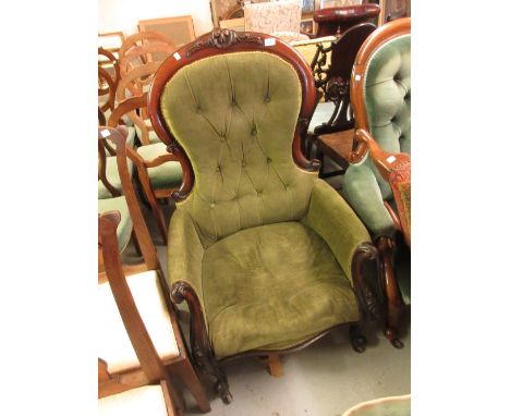 Victorian carved mahogany green button upholstered spoon back armchair on cabriole front supports 