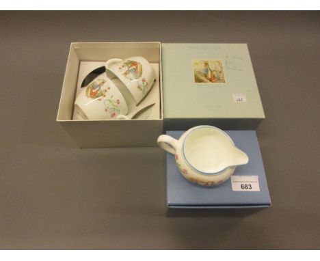 Two boxed Wedgwood Peter Rabbit cups and saucers, together with similar boxed jug 