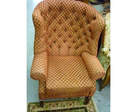 Reproduction button upholstered wing armchair in 18th Century style on square cut moulded supports with stretchers 